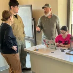 Student Madison Green studies coins at the museum Chianti Origo, with help from Dr. de Grummond, Kenneth Everett Reckford and David Reckford